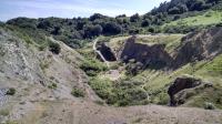 Looking down into an old quarry pit, and a volcano.